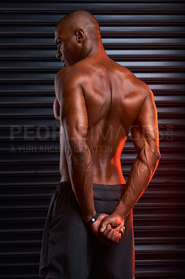 Buy stock photo Rearview shot of an athletic young man posing against a grey background