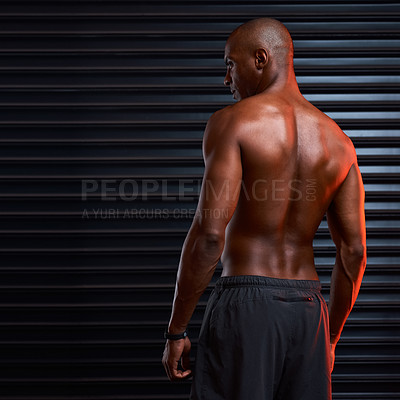 Buy stock photo Rearview shot of an athletic young man posing against a grey background
