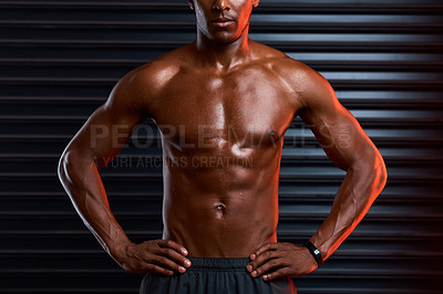 Buy stock photo Studio shot of an unrecognizable male athlete posing with his hands on his hips against a grey background