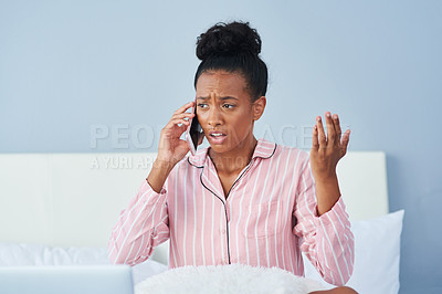 Buy stock photo Shot of an attractive young woman taking a phone call in bed at home