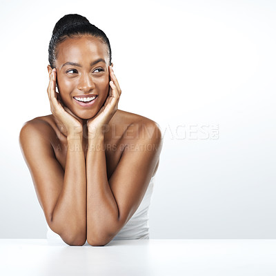 Buy stock photo Studio shot of an attractive young woman resting her face in the palm of her hands while standing against a white background