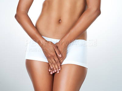 Buy stock photo Studio shot of an unrecognizable young woman posing in her underwear against a grey background