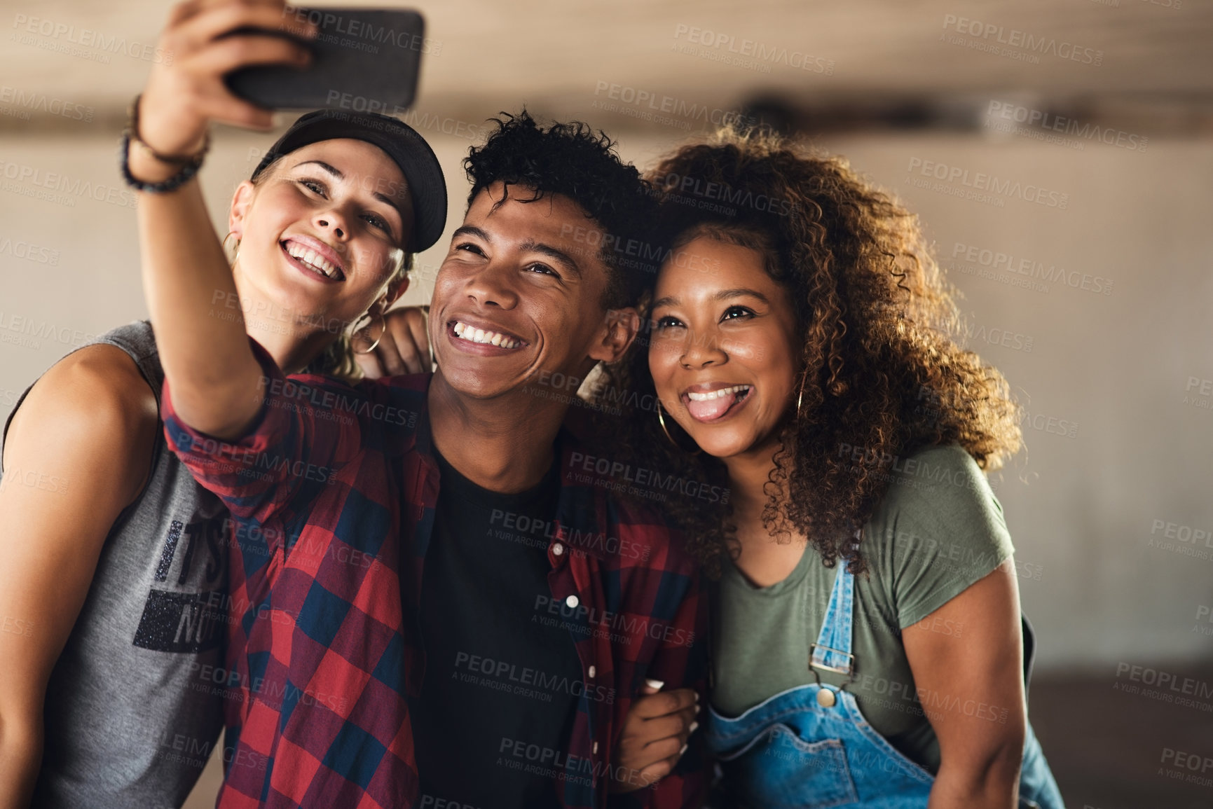 Buy stock photo Portrait of a group of cheerful young friends posing for a self portrait together while outside in a parking lot