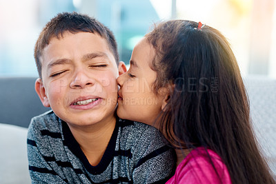 Buy stock photo Young, children and happy with kiss on cheek, smile and joy in family home as kids in youth. Siblings, cute and cuddle as brother and sister on couch for affection, love and childhood development