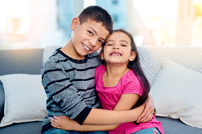 Buy stock photo Siblings, hug and portrait of kids in home on sofa to relax with care or support of happy family. Girl, brother or children embrace with love, kindness or friends on holiday and vacation in Mexico