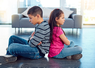 Buy stock photo Angry, brother and sister in home living room, fighting or argument, conflict or problem. Anger, children and kids sitting with arms crossed on floor with their backs together, frustrated and cross.