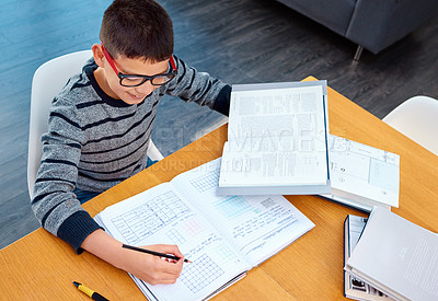 Buy stock photo Happy boy, student and writing on math book for studying, learning or education on table at home. Smart little kid or child busy with mathematics homework, textbook or problem solving on study desk