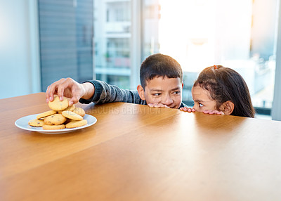 Buy stock photo Home, brother and sister in kitchen, biscuits and siblings together, boy and girl in morning or hungry. House, kid and cute child for food or cookies on table, plate and bonding or dessert in weekend