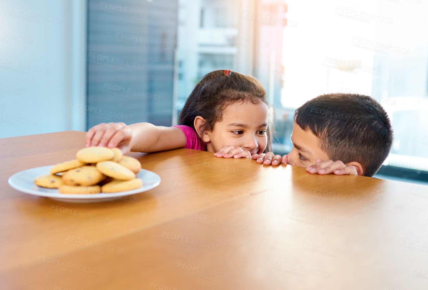 Buy stock photo Home, girl and boy in kitchen, cookies and siblings together, brother and sister in morning or hungry. House, kid and cute child for bonding or biscuits on table, plate and food or dessert in weekend