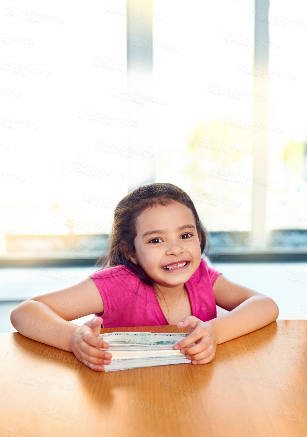 Buy stock photo Money, portrait and smile of girl child at table in home for finance, future saving or wealth. Accounting, cash and development with happy young kid in apartment for economy, growth or learning