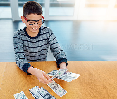 Buy stock photo Savings, young child counting money and sitting at desk at his home. Finance or investing, financial management or wealth planning and happy male kid with cash for future investment in house