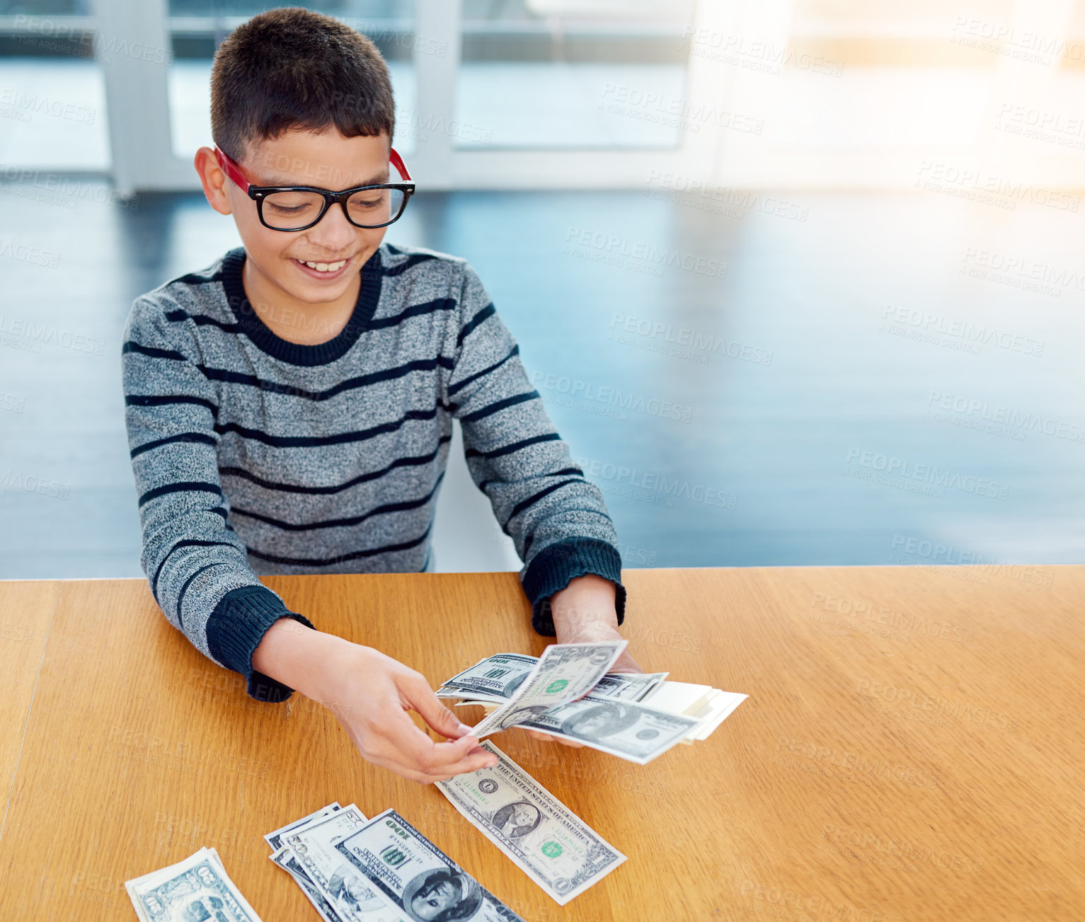 Buy stock photo Savings, young child counting money and sitting at desk at his home. Finance or investing, financial management or wealth planning and happy male kid with cash for future investment in house