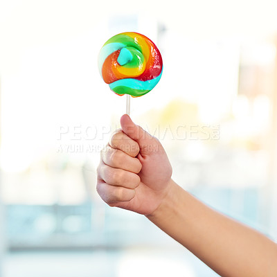 Buy stock photo Hand, lollipop and candy for kid, home and mockup for sugar, show and promotion for sweets for snack. House, growth and development of child, dessert and unhealthy food, spiral and color of treat
