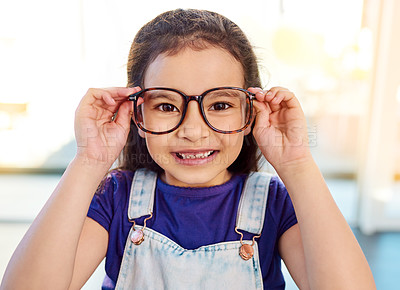 Buy stock photo Portrait of an adorable little girl posing with glasses on at home