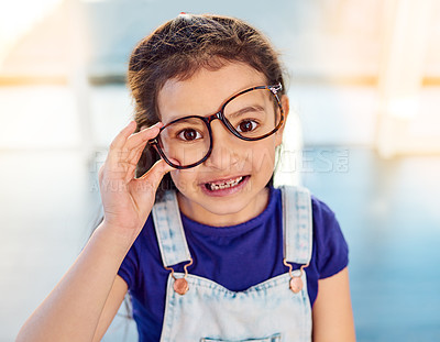 Buy stock photo Girl child, portrait, glasses and growth for spring, happy and development at home. Kid, smile or eyewear with youth fashion, modern clothes and casual style in house with confidence and frame
