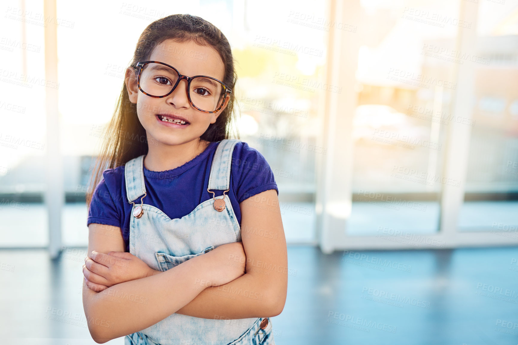 Buy stock photo Portrait of an adorable little girl with glasses on posing with her arms folded at home