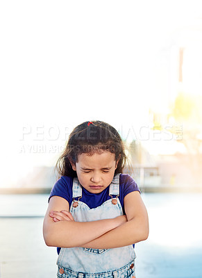 Buy stock photo Shot of a sad little girl posing eyes closed and with arms folded at home