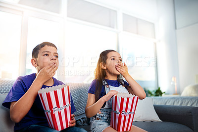 Buy stock photo Children, popcorn and television on home sofa for movie entertainment as siblings, subscription or eating. Boy, girl and couch in apartment with snacks together in living room, streaming or relax