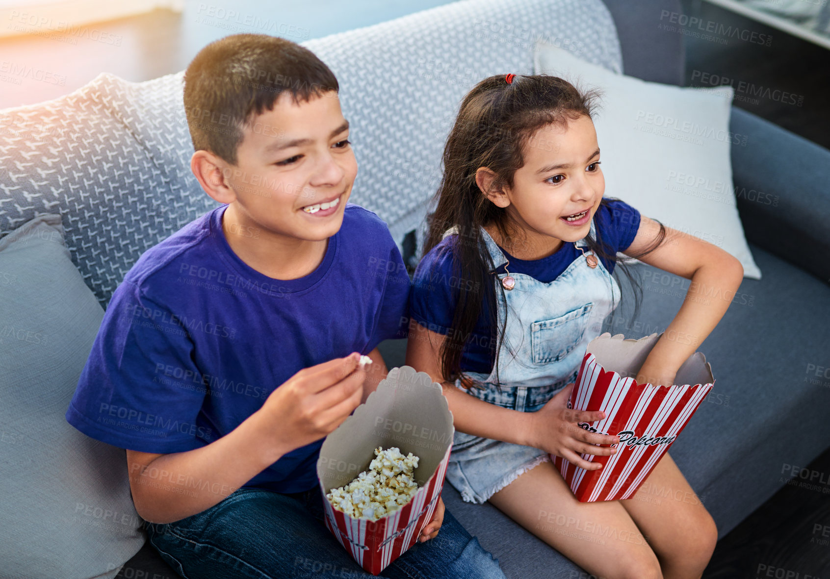 Buy stock photo Children, popcorn and television or excited in home for movie entertainment as siblings, subscription or eat. Boy, girl and couch in apartment with snacks together in living room, streaming or film