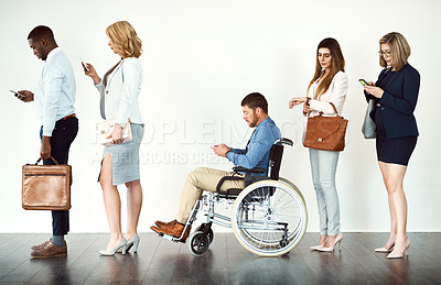 Buy stock photo Studio shot of a group o focused people in a row behind each other against a white background