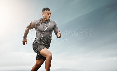 Buy stock photo Shot of a sporty young man running outdoors