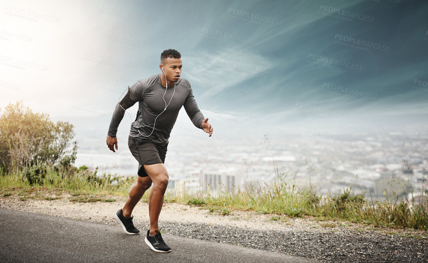 Buy stock photo Man, runner and space in street with cityscape for exercise, wellness or music with mockup for health. African male running, listening and audio for focus, workout and outdoor with mock up on road