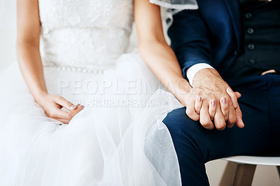 Buy stock photo Studio shot of two unrecognizable young newlyweds holding hands against a gray background
