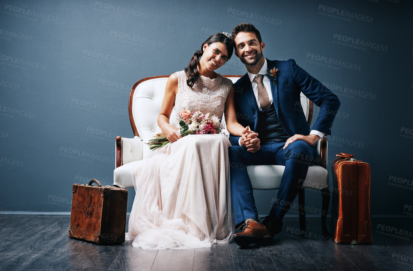 Buy stock photo Groom, bride and portrait on couch for wedding, relationship and love with holding hands or flowers. Couple, happy and  people on sofa for marriage, celebration and bonding together with mockup space