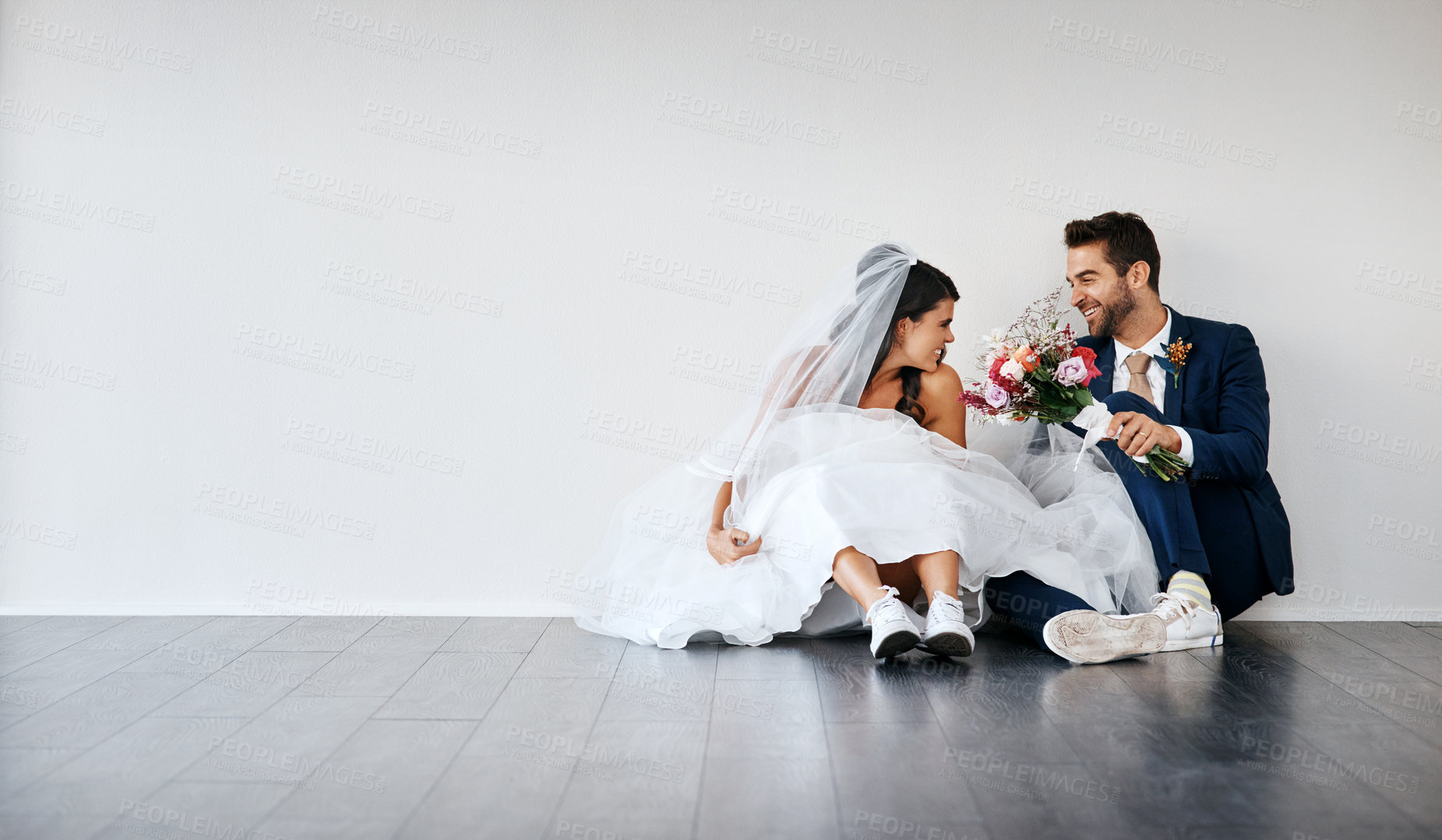 Buy stock photo Bride, groom and smile in studio for marriage with bouquet, wedding and celebration together. Happy couple, unity and commitment for love, excited and partnership on floor and white background