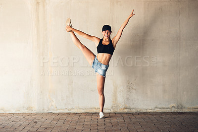 Buy stock photo Shot of an attractive young female street dancer practising out in the city