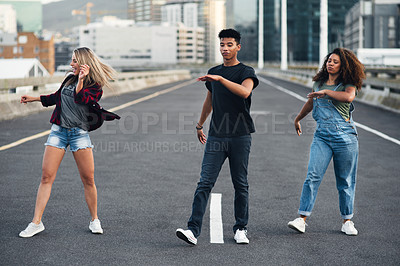 Buy stock photo Full length shot of a group of dancers dancing in the street