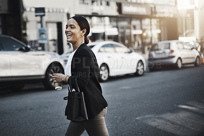 Buy stock photo Shot of a young businesswoman walking in the city