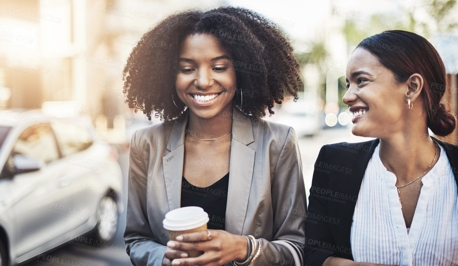 Buy stock photo Shot of two businesswomen walking in the city