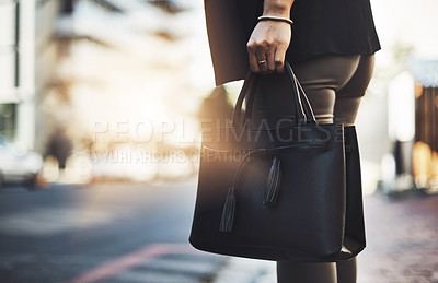Buy stock photo Closeup shot of a businesswoman walking with her handbag in the city