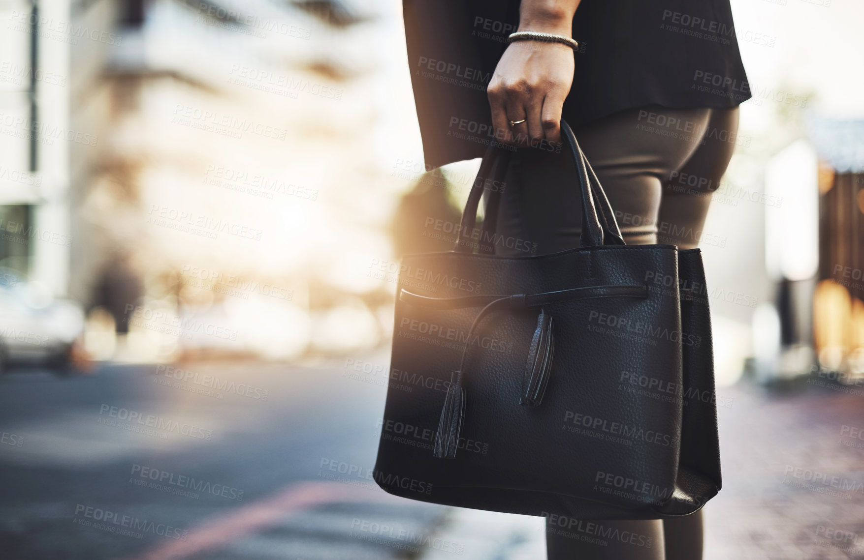 Buy stock photo Closeup shot of a businesswoman walking with her handbag in the city