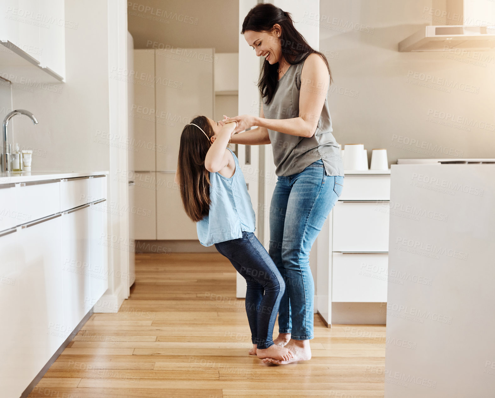 Buy stock photo Shot of an adorable little girl dancing with her mother at home
