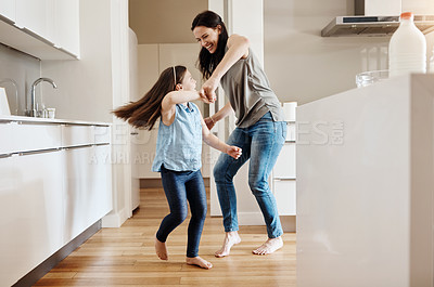 Buy stock photo Happy, dance and a child with a mother in the kitchen, bonding and quality time together. Smile, laughing and a mom teaching her daughter with dancing, love and happiness with fun in a house