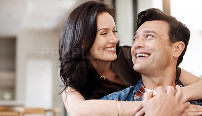 Buy stock photo Shot of a happy young couple embracing at home