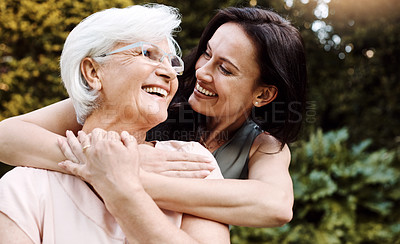 Buy stock photo Shot of a happy senior woman spending quality time with her daughter outdoors