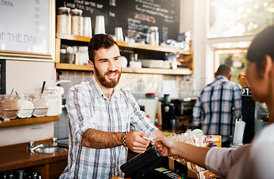 Buy stock photo Shot of a shop assistant helping a customer in a cafe