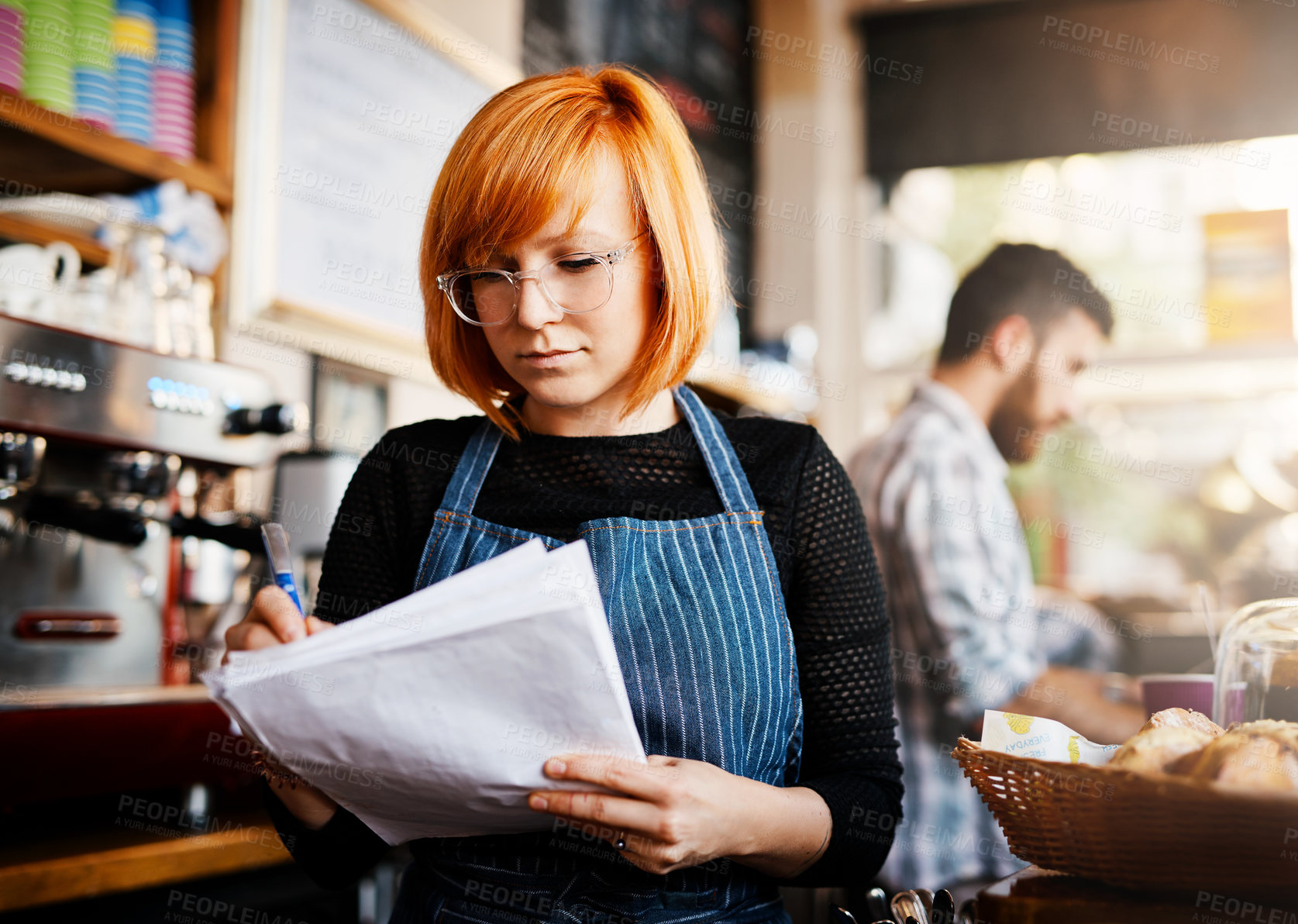 Buy stock photo Woman, shop owner and writing with paperwork at cafe with list for supply, stock or inventory at startup. Person, barista or entrepreneur with documents, reading or thinking in morning at restaurant