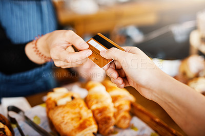Buy stock photo Cropped shot of a shop assistant receiving a card payment from a customer