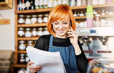 Buy stock photo Woman, business owner and phone call at coffee shop with document, reading or smile for order, stock and deal. Person, smartphone and paperwork for invoice, inventory or contact supplier in cafeteria