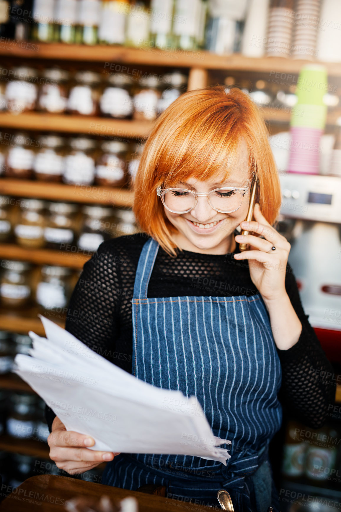 Buy stock photo Woman, phone call and coffee shop owner with documents, thinking and smile for price, stock and deal. Happy barista, smartphone and paperwork for invoice, inventory and contact supplier in cafeteria