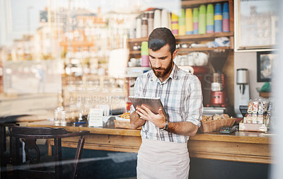 Buy stock photo Tablet, business owner and man in a coffee shop doing inventory while working on a startup plan in a restaurant. Cafeteria, entrepreneur and male barista doing research on digital technology in cafe.