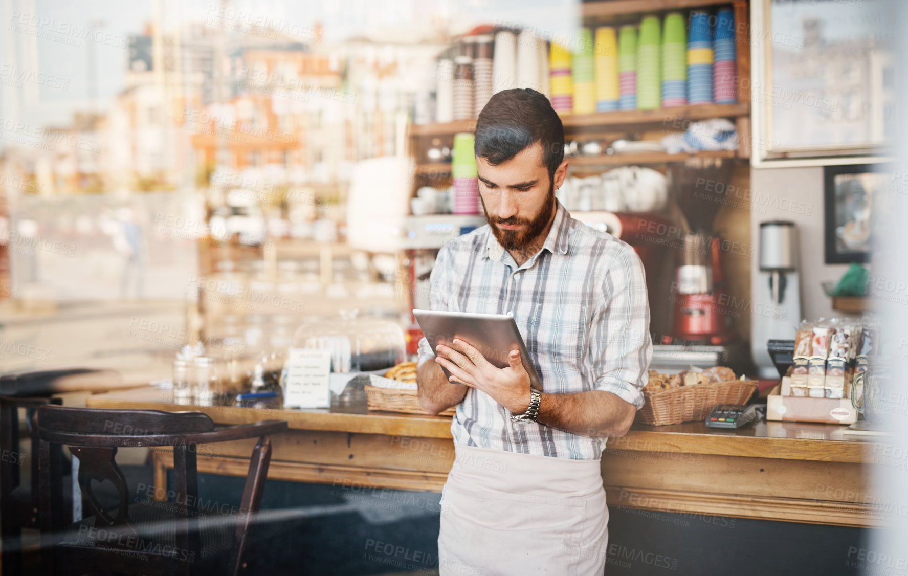 Buy stock photo Tablet, business owner and man in a coffee shop doing inventory while working on a startup plan in a restaurant. Cafeteria, entrepreneur and male barista doing research on digital technology in cafe.