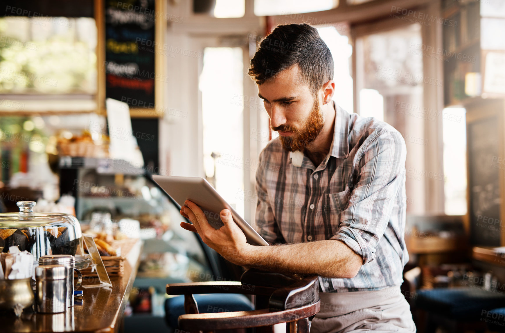 Buy stock photo Barista, man and tablet for coffee shop inventory or online order on website in startup cafe. Small business owner, waiter and review with technology for stock menu or price checklist in store