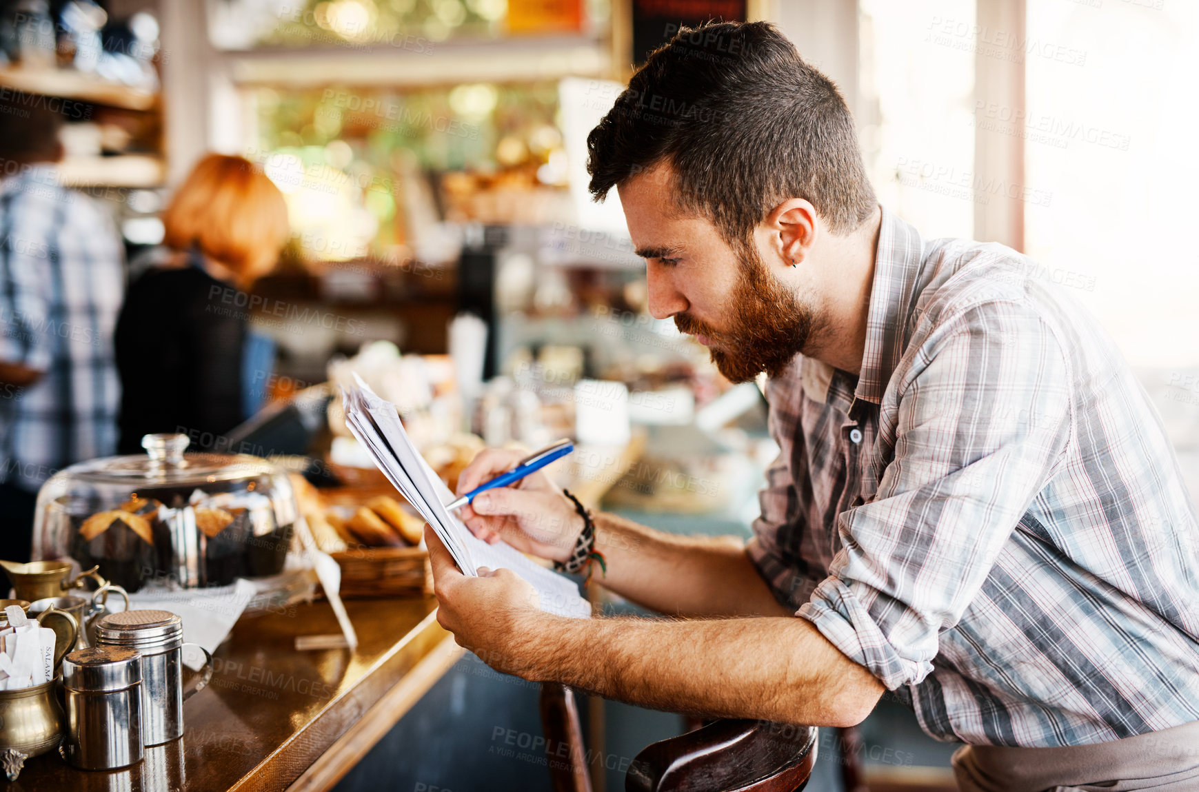 Buy stock photo Coffee shop, writing and man with checklist for menu items, stock and product inventory. Restaurant, cafeteria and business owner with paperwork for planning, client order and documents by counter