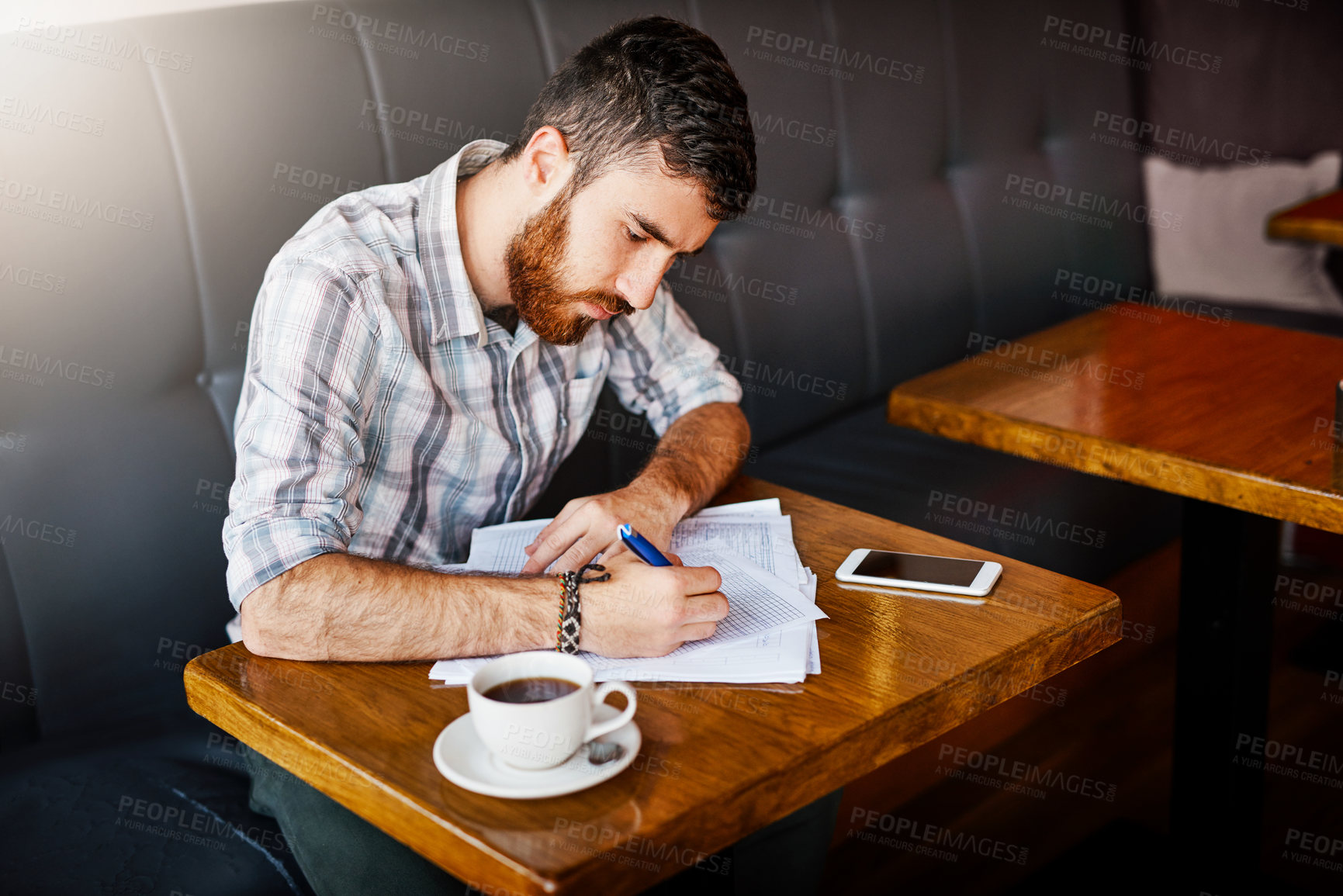 Buy stock photo Man, coffee shop and writing with paperwork for small business as manager for inventory or stock. Male person, table and planning for food menu, restaurant or bistro as owner in hospitality industry