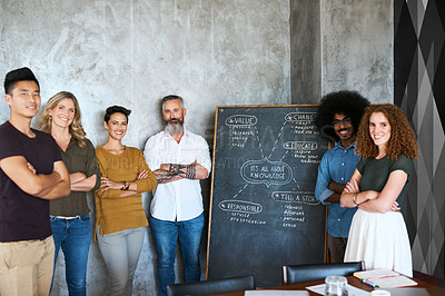 Buy stock photo Cropped portrait of a group of designers standing with their arms folded in an office